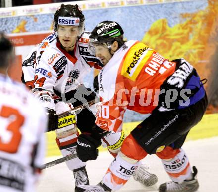 Eishockey Oesterreich Cup. Oesterreich gegen Schweiz.  Daniel Woger,  (Oesterreich), Andreas Ambuehl (Schweiz). Klagenfurt, 16.12.2011.
Foto: Kuess

---
pressefotos, pressefotografie, kuess, qs, qspictures, sport, bild, bilder, bilddatenbank