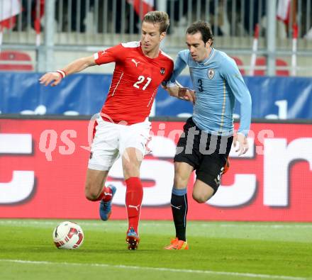 Fussball Laenderspiel. Oesterreich gegen Uruguay. Marc Janko, (Oesterreich), Diego Godin  (Uruguay). Klagenfurt, 5.3.2014.
Foto: Kuess

---
pressefotos, pressefotografie, kuess, qs, qspictures, sport, bild, bilder, bilddatenbank