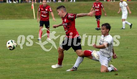 Fussball Kaerntner Liga. ATUS Ferlach gegen Koettmannsdorf.  Dominik Mak (Ferlach),  Daniel Hans Genser (Koettmannsdorf). Ferlach, 14.8.2024.
Foto: Kuess
www.qspictures.net
---
pressefotos, pressefotografie, kuess, qs, qspictures, sport, bild, bilder, bilddatenbank